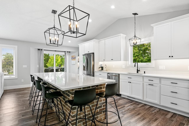 1600 Buffalo Cv, Buffalo, MN 55313 - kitchen with appliances with stainless steel finishes, a sink, a chandelier, dark wood-style flooring, and a center island