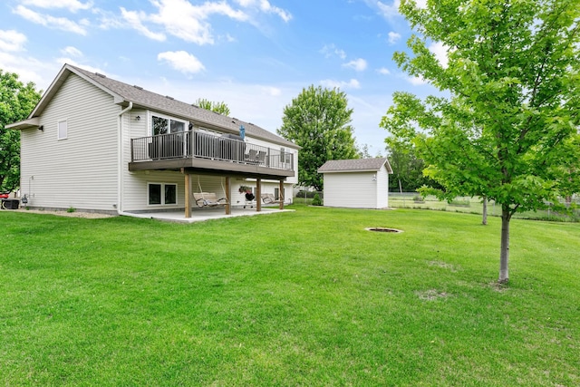 1600 Buffalo Cv, Buffalo, MN 55313 - rear view of property with a fire pit, a patio, a deck, a lawn, and an outdoor structure