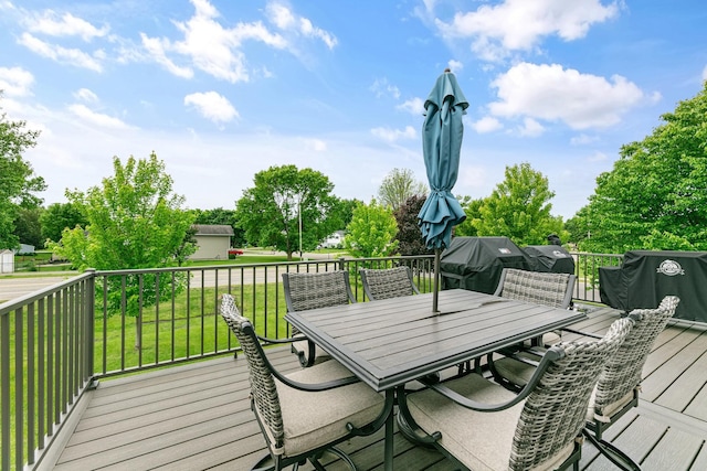 1600 Buffalo Cv, Buffalo, MN 55313 - wooden deck featuring outdoor dining area, a yard, area for grilling, and view of scattered trees