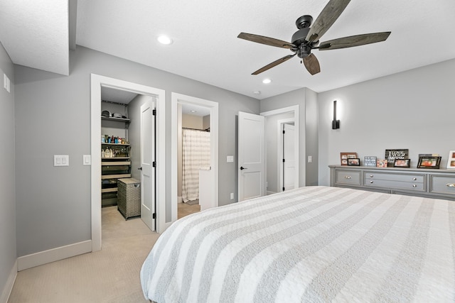 1600 Buffalo Cv, Buffalo, MN 55313 - bedroom featuring light colored carpet, a walk in closet, baseboards, a ceiling fan, and ensuite bathroom