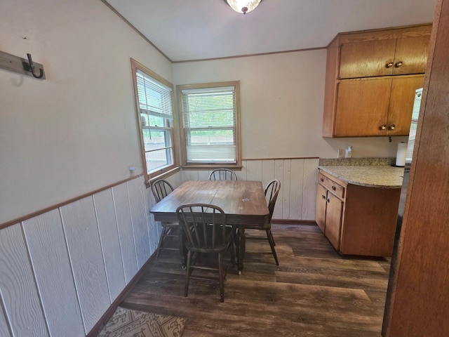 1331 9th St, Grand Rapids, MN 55744 - dining space with wainscoting, dark wood-type flooring, wooden walls, and crown molding