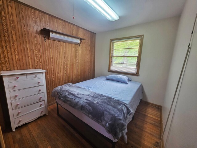 1331 9th St, Grand Rapids, MN 55744 - bedroom featuring dark wood-type flooring and wooden walls