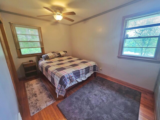 1331 9th St, Grand Rapids, MN 55744 - bedroom with wood finished floors, ceiling fan, crown molding, and baseboards