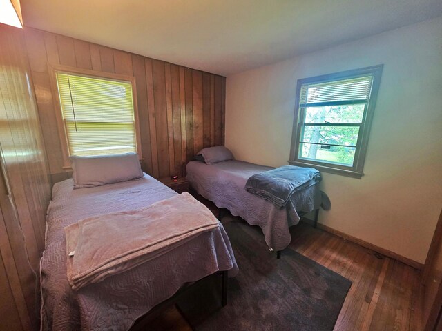 1331 9th St, Grand Rapids, MN 55744 - bedroom featuring hardwood / wood-style floors, wooden walls, and baseboards