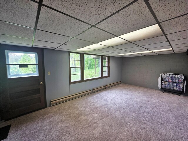 1331 9th St, Grand Rapids, MN 55744 - basement with a baseboard heating unit, a paneled ceiling, carpet flooring, and concrete block wall
