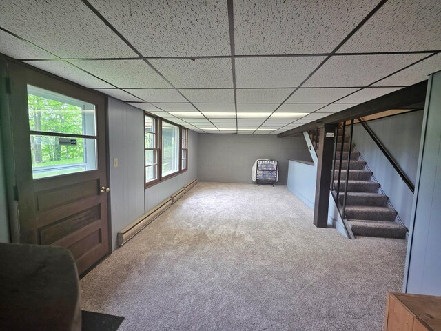 1331 9th St, Grand Rapids, MN 55744 - below grade area with a baseboard radiator, carpet flooring, stairs, and a paneled ceiling