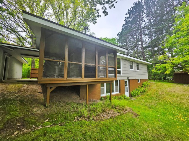 1331 9th St, Grand Rapids, MN 55744 - back of property featuring a sunroom and a yard
