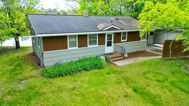 1331 9th St, Grand Rapids, MN 55744 - view of front of home with a shingled roof, a front lawn, and a chimney