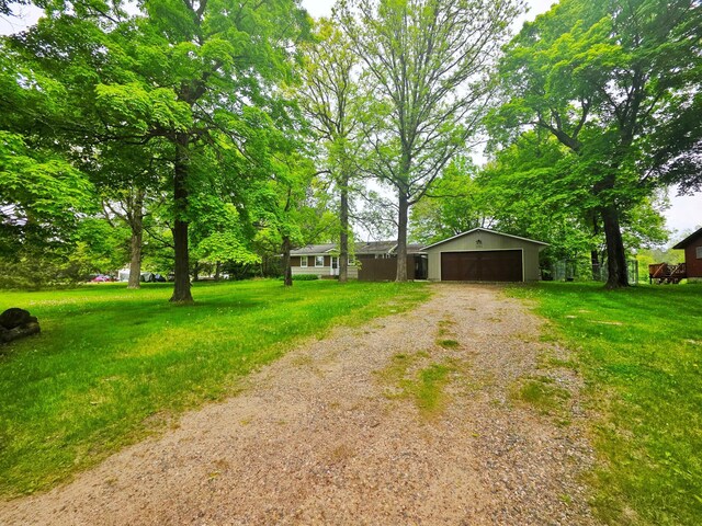 1331 9th St, Grand Rapids, MN 55744 - view of front of home with a garage and a front lawn