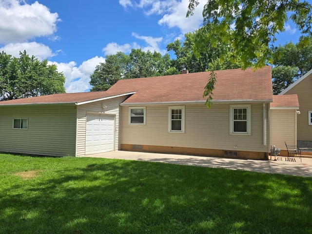1156 River Rd, Windom, MN 56101 - back of property featuring a garage, a lawn, and a chimney