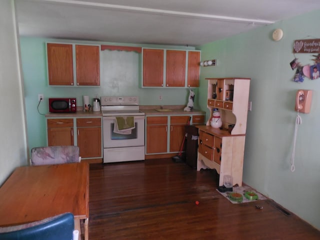 1156 River Rd, Windom, MN 56101 - kitchen with white electric stove, dark wood-type flooring, light countertops, and brown cabinets
