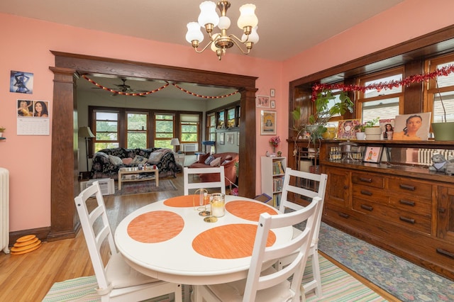 1808 Taylor St NE, Minneapolis, MN 55418 - dining area with light wood finished floors, a chandelier, and radiator heating unit