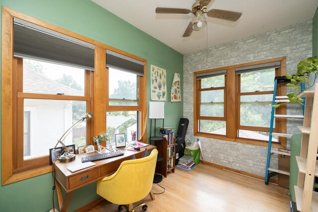 1808 Taylor St NE, Minneapolis, MN 55418 - office featuring wood finished floors, ceiling fan, and brick wall