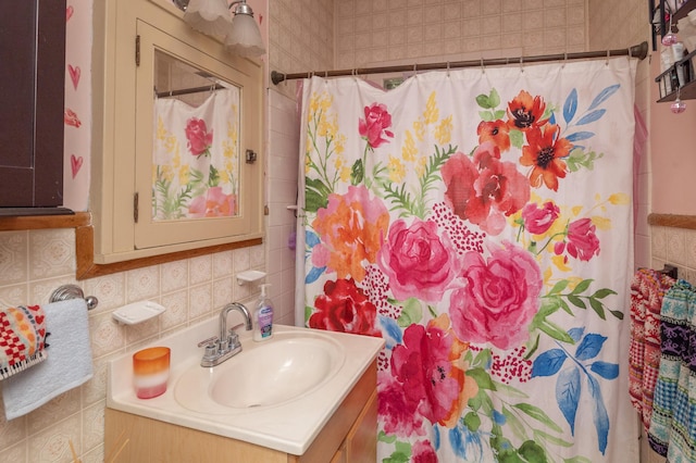 1808 Taylor St NE, Minneapolis, MN 55418 - bathroom featuring vanity, tile walls, a shower with curtain, and decorative backsplash