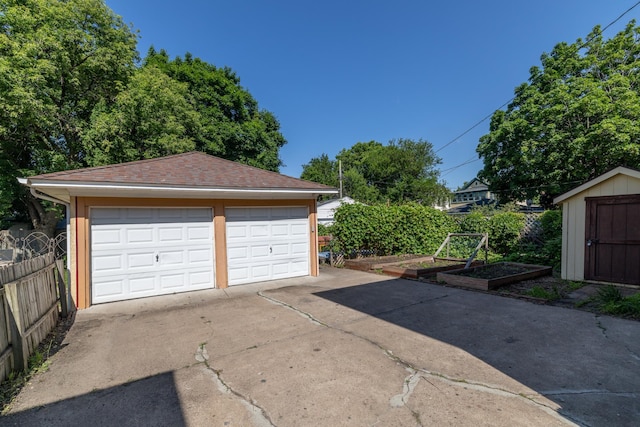 1808 Taylor St NE, Minneapolis, MN 55418 - detached garage featuring a garden and a storage unit