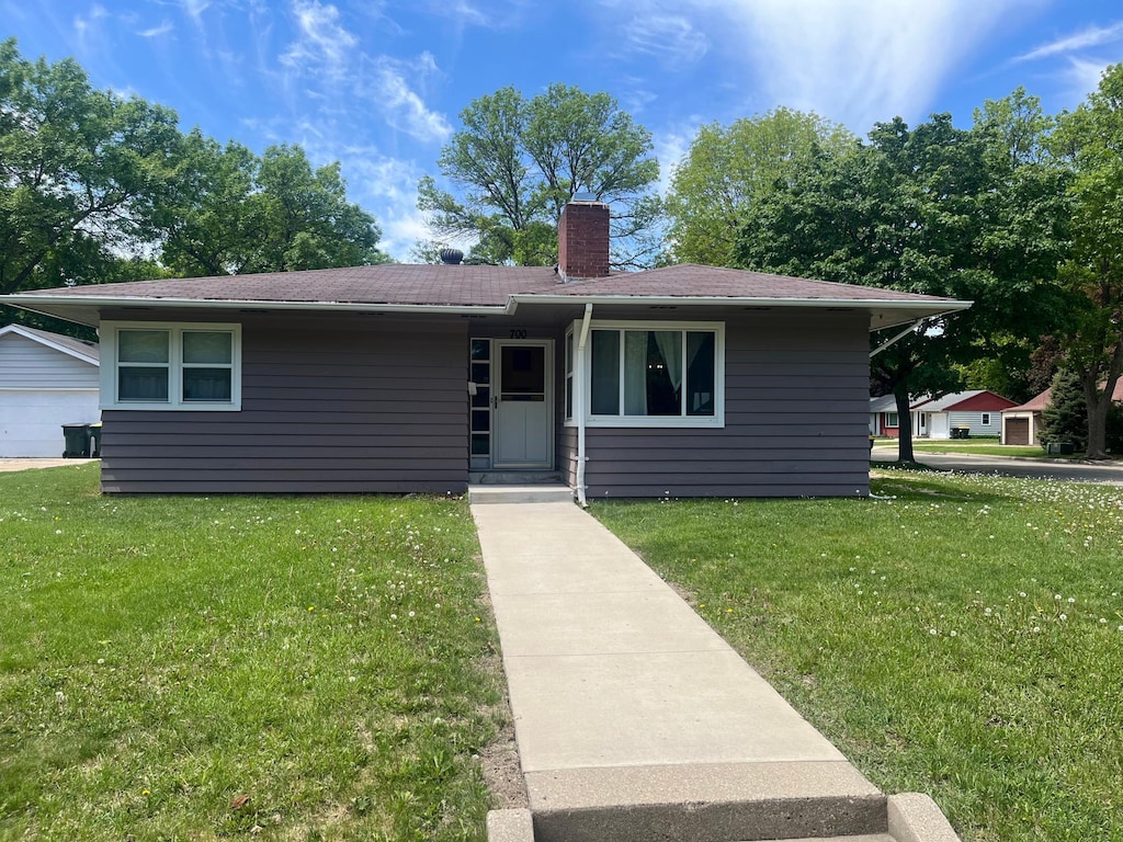 700 14th St SW, Willmar, MN 56201 - view of front of property featuring a front yard and a chimney