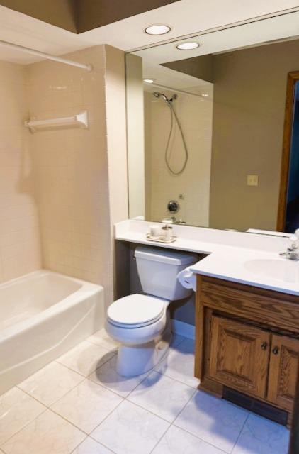 9693 Falcons Way, Eden Prairie, MN 55347 - bathroom featuring tile patterned flooring, shower / washtub combination, toilet, and vanity