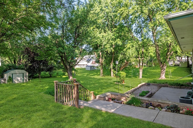 601 4th Ave N, Sauk Rapids, MN 56379 - view of grassy yard with a shed and a patio