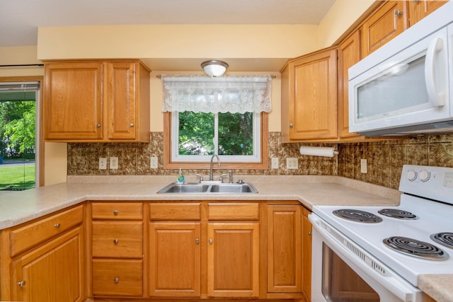 601 4th Ave N, Sauk Rapids, MN 56379 - kitchen with white appliances, light countertops, decorative backsplash, and brown cabinets