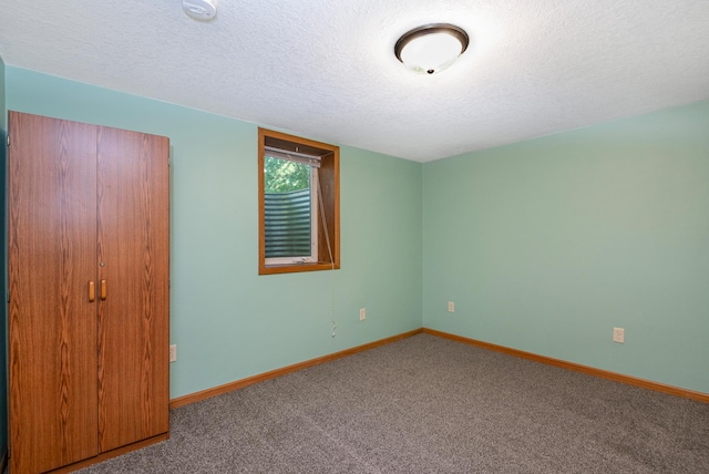601 4th Ave N, Sauk Rapids, MN 56379 - unfurnished bedroom featuring carpet floors and a textured ceiling