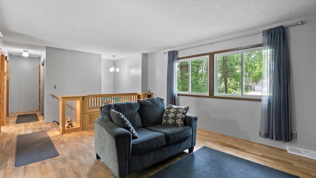 1504 89th Ave N, Brooklyn Park, MN 55444 - living area featuring a textured ceiling and light wood-type flooring