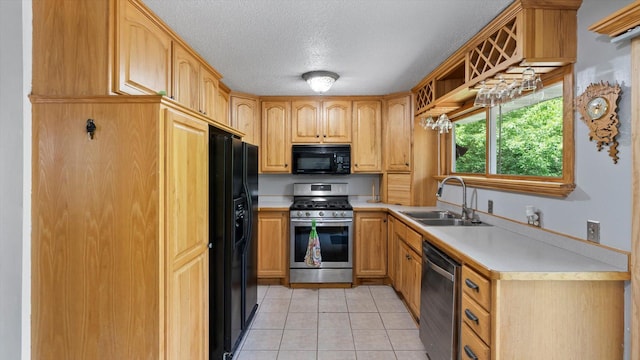 1504 89th Ave N, Brooklyn Park, MN 55444 - kitchen featuring black appliances, a sink, light countertops, light tile patterned floors, and a textured ceiling