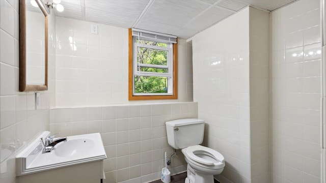 1504 89th Ave N, Brooklyn Park, MN 55444 - bathroom with tile walls, toilet, and vanity