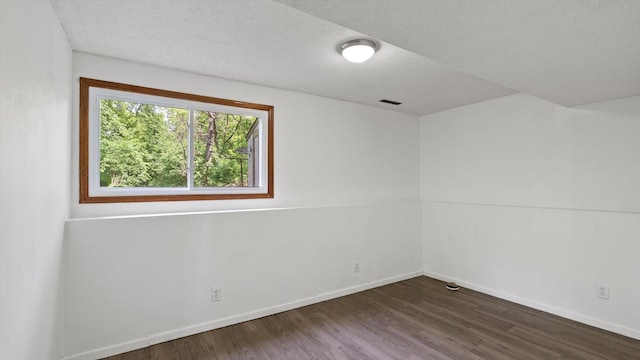 1504 89th Ave N, Brooklyn Park, MN 55444 - unfurnished room with wood finished floors, baseboards, and a textured ceiling