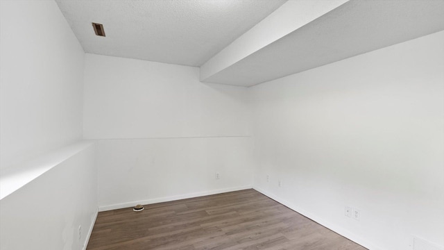 1504 89th Ave N, Brooklyn Park, MN 55444 - spare room with wood finished floors, baseboards, and a textured ceiling