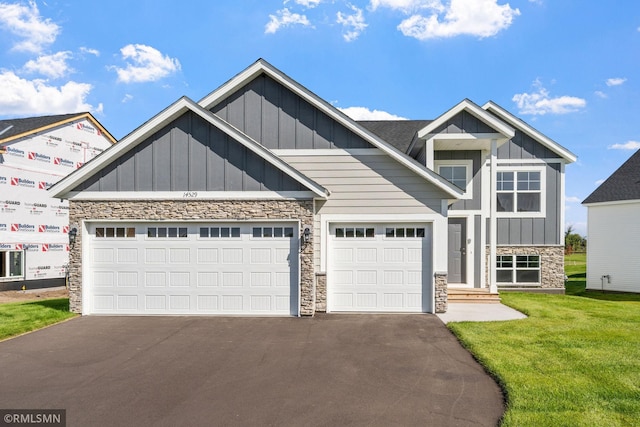 1020 2nd St NW, Delano, MN 55328 - craftsman inspired home with stone siding, board and batten siding, asphalt driveway, and an attached garage