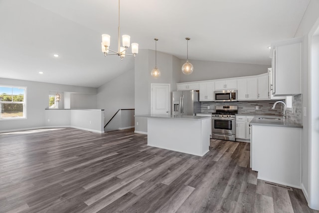 1020 2nd St NW, Delano, MN 55328 - kitchen with appliances with stainless steel finishes, a sink, open floor plan, tasteful backsplash, and white cabinetry