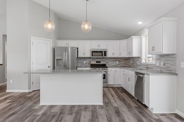 1020 2nd St NW, Delano, MN 55328 - kitchen with stainless steel appliances, a sink, decorative backsplash, white cabinets, and high vaulted ceiling