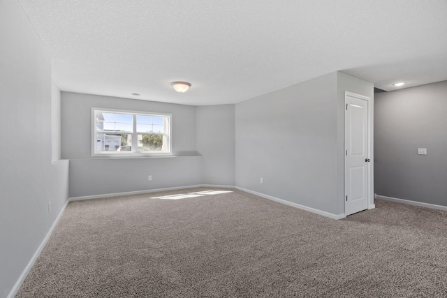 1020 2nd St NW, Delano, MN 55328 - carpeted spare room with baseboards and a textured ceiling