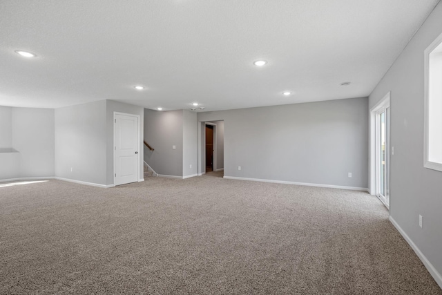 1020 2nd St NW, Delano, MN 55328 - spare room with light colored carpet, recessed lighting, baseboards, and stairway