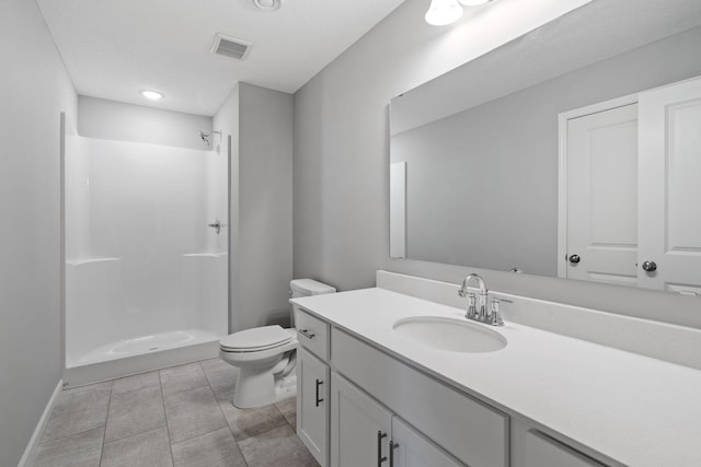 1020 2nd St NW, Delano, MN 55328 - bathroom featuring a shower, toilet, vanity, baseboards, and tile patterned floors