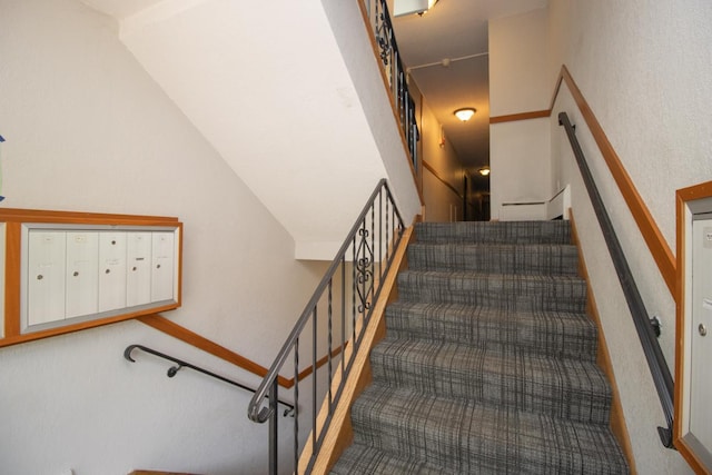 3018 Aldrich Ave S Unit 12, Minneapolis, MN 55408 - stairway featuring mail area, carpet flooring, and vaulted ceiling