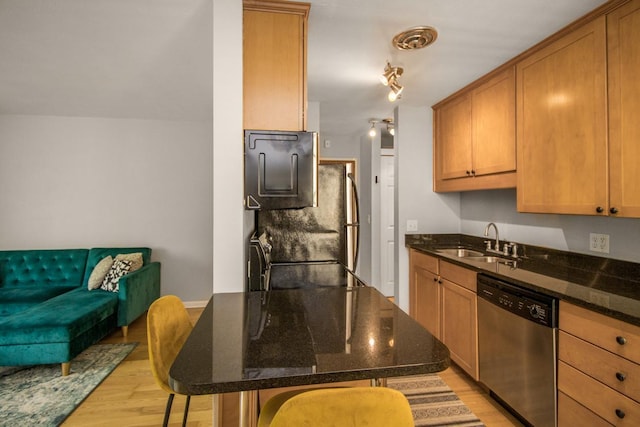 3018 Aldrich Ave S Unit 12, Minneapolis, MN 55408 - kitchen with dishwasher, a sink, light wood-style floors, a breakfast bar area, and dark stone counters