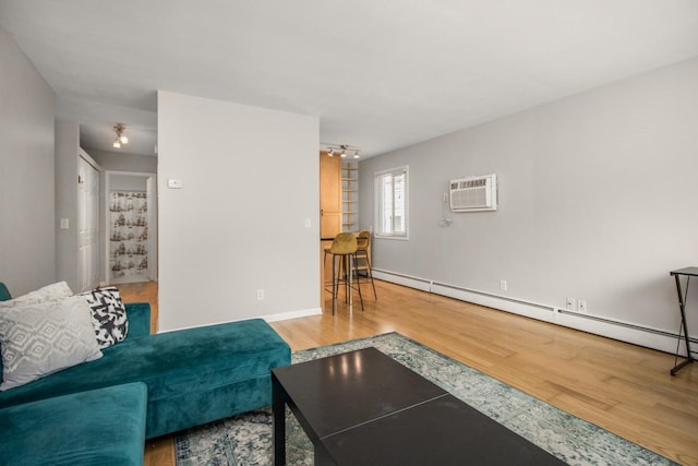 3018 Aldrich Ave S Unit 12, Minneapolis, MN 55408 - living room with wood finished floors, baseboard heating, a wall unit AC, and baseboards