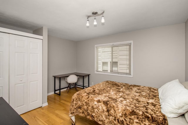 3018 Aldrich Ave S Unit 12, Minneapolis, MN 55408 - bedroom with light wood finished floors, a closet, and baseboards