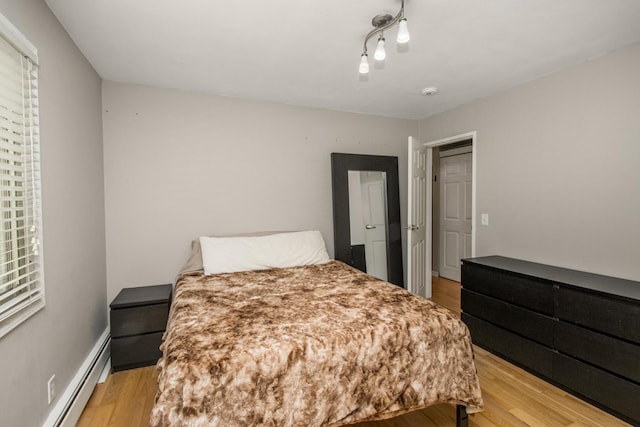 3018 Aldrich Ave S Unit 12, Minneapolis, MN 55408 - bedroom featuring light wood finished floors and baseboard heating