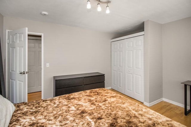 3018 Aldrich Ave S Unit 12, Minneapolis, MN 55408 - unfurnished bedroom with wood finished floors, a closet, and baseboards