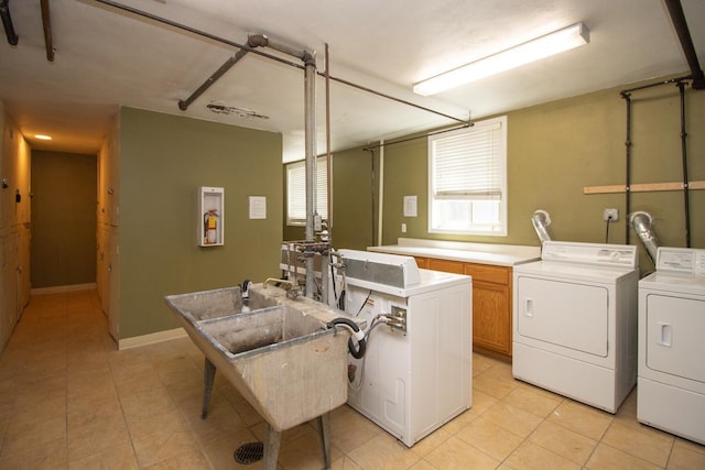3018 Aldrich Ave S Unit 12, Minneapolis, MN 55408 - laundry room with cabinet space, independent washer and dryer, and light tile patterned floors