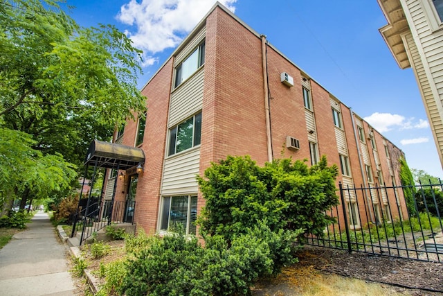 3018 Aldrich Ave S Unit 12, Minneapolis, MN 55408 - view of building exterior with a wall mounted air conditioner