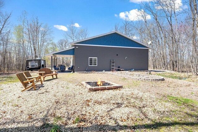 40276 Fairway Ln, Onamia, MN 56359 - back of house with a fire pit and a patio area