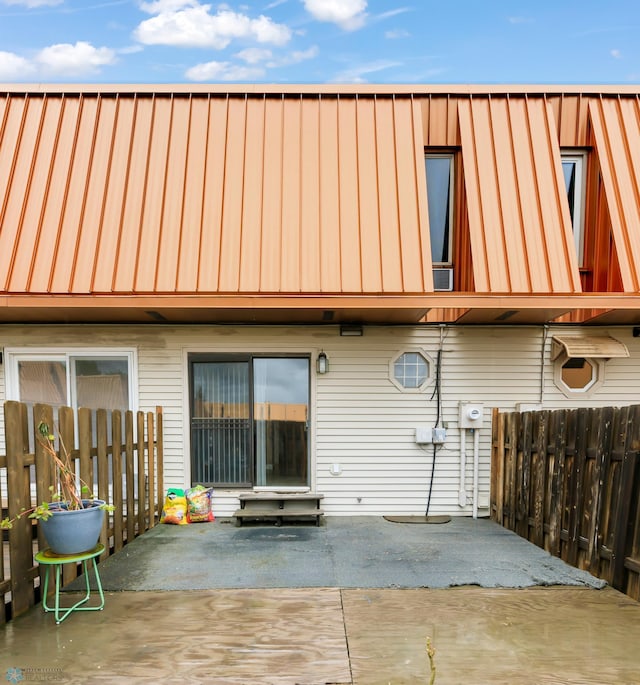 309 12 1/2 Ave E, West Fargo, ND 58078 - rear view of house featuring a patio, a standing seam roof, and metal roof