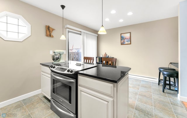309 12 1/2 Ave E, West Fargo, ND 58078 - kitchen with electric range, dark countertops, a baseboard radiator, baseboards, and white cabinetry