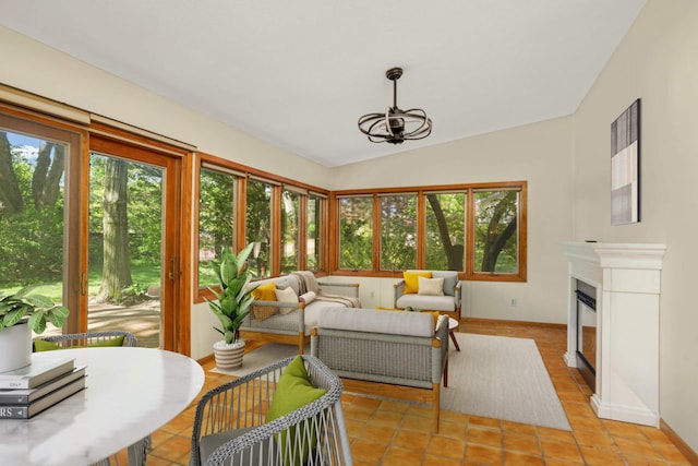 15423 Boulder Creek Dr, Minnetonka, MN 55345 - sunroom with plenty of natural light, vaulted ceiling, a chandelier, baseboards, and tile patterned flooring