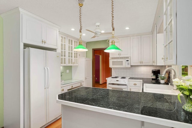 15423 Boulder Creek Dr, Minnetonka, MN 55345 - kitchen with white appliances, a sink, white cabinets, recessed lighting, and glass insert cabinets