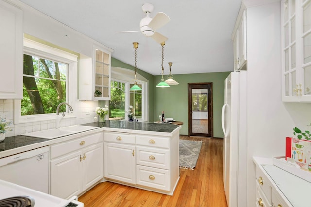 15423 Boulder Creek Dr, Minnetonka, MN 55345 - kitchen with white appliances, a peninsula, a sink, white cabinets, and decorative backsplash