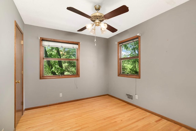 15423 Boulder Creek Dr, Minnetonka, MN 55345 - spare room with healthy amount of natural light, baseboards, light wood finished floors, and a ceiling fan